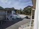 Community outdoor pool area, surrounded by chairs and lush greenery, next to building at 2204 S Perrin Dr. # 3, North Myrtle Beach, SC 29582