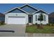 Charming one-story home featuring a two-car garage, lovely landscaping, and a light blue facade at 2832 Riverboat Way, Conway, SC 29526