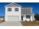 Two-story home with a two-car garage, white siding, gray accents and a well manicured lawn at 335 Glade Ct., Loris, SC 29569