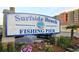 Surfside Beach Fishing Pier sign with colorful flowers in front of a clear sky at 344 Bayou Loop # Lot 72, Surfside Beach, SC 29575