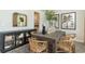 Dining room featuring a wooden table, unique wicker chairs, and a stylish storage cabinet at 374 Glacier Way, Conway, SC 29526