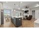 Open kitchen with island seating, stainless appliances, and view of fireplace and dining area at 389 Bumble Circle, Murrells Inlet, SC 29576