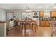 Inviting dining area leading into kitchen featuring wooden table set and hardwood floors at 390 Boundary Ave., Murrells Inlet, SC 29576