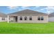 View of the home's backyard featuring a lawn and large windows at 402 Clear Lake Dr., Conway, SC 29526