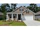 Charming single-Gathering home features a two-car garage, manicured lawn, and inviting front entrance at 402 Clear Lake Dr., Conway, SC 29526