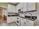 Beautiful kitchen features white cabinetry and sleek black countertops, combining style and functionality at 48 Heston Ct., Pawleys Island, SC 29585