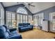 Sun-drenched living room boasts vaulted ceilings and large windows, creating a bright and airy retreat at 48 Heston Ct., Pawleys Island, SC 29585