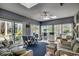 Bright sunroom featuring comfortable seating and multiple sliding doors that bring the outdoors inside at 48 Heston Ct., Pawleys Island, SC 29585