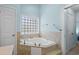 Bathroom featuring a soaking tub, tile floor and light blue walls at 6001- 5411 S Kings Highway, Myrtle Beach, SC 29575