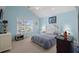 Bright bedroom with a large window, white furniture, blue walls, and a comfortable bed at 6001- 5411 S Kings Highway, Myrtle Beach, SC 29575