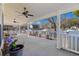 Expansive covered deck with ceiling fans, potted plants, and outdoor seating, perfect for relaxation at 6001- 5411 S Kings Highway, Myrtle Beach, SC 29575