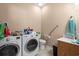 Bright laundry room with washer, dryer, toilet, sink, and grab bar at 6001- 5411 S Kings Highway, Myrtle Beach, SC 29575