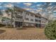 Charming condominium building with screened porches, multiple windows, and beautifully maintained landscaping at 6015 Catalina Dr. # 734, North Myrtle Beach, SC 29582