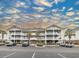 Beautiful condominium building featuring multiple stories, exterior stairs, and ample parking at 6015 Catalina Dr. # 734, North Myrtle Beach, SC 29582