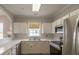 Bright kitchen with stainless steel appliances, white cabinets, and a window with pleasant outdoor view at 6015 Catalina Dr. # 734, North Myrtle Beach, SC 29582