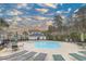 Sparkling outdoor swimming pool with lounge chairs, umbrellas, and nearby building for shade at 6015 Catalina Dr. # 734, North Myrtle Beach, SC 29582