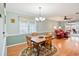 Charming dining room with classic wood furniture and inviting views to the living room at 6644 Cinnamon Fern Ln., Myrtle Beach, SC 29588