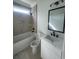 Bathroom featuring tiled shower/tub, toilet, sink, and black fixtures at 740 Jade Dr., Myrtle Beach, SC 29579