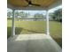 Covered patio with ceiling fan overlooking lush green lawn and picturesque pond at 740 Jade Dr., Myrtle Beach, SC 29579