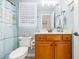 Bathroom featuring wood vanity, a framed mirror, and coastal accents at 920 Sewing Bee Pl., Little River, SC 29566