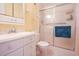 Bright bathroom features a white vanity, toilet, and shower with a blue towel at 9501 Shore Dr. # A309, Myrtle Beach, SC 29572