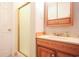 Bathroom vanity with wood cabinets, sink, and a shower with a sliding glass door at 9501 Shore Dr. # A309, Myrtle Beach, SC 29572