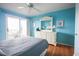 Bright bedroom with wooden floors, sliding door to outdoor porch, and white bedroom furniture at 9501 Shore Dr. # A309, Myrtle Beach, SC 29572