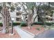 Apartment building exterior surrounded by lush greenery and palm trees at 9501 Shore Dr. # A309, Myrtle Beach, SC 29572