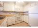 Well-lit kitchen with white appliances, cabinets, and tile floors at 9501 Shore Dr. # A309, Myrtle Beach, SC 29572