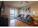 Comfortable living room with hardwood floors and sliding glass doors to screened in outdoor porch at 9501 Shore Dr. # A309, Myrtle Beach, SC 29572