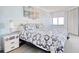 Serene bedroom with a plush bed, ocean-themed decor, and a bright window offering natural light at 9650 Shore Dr. # 503, Myrtle Beach, SC 29572