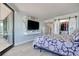 Bright bedroom with a view, featuring a plush bed, large TV, and closet with sliding doors at 9650 Shore Dr. # 503, Myrtle Beach, SC 29572
