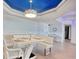 Elegant dining area features a modern white table, stylish chairs, and a unique light fixture at 9650 Shore Dr. # 503, Myrtle Beach, SC 29572
