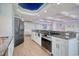 Modern kitchen with stainless steel appliances, granite countertops, and sleek white cabinetry at 9650 Shore Dr. # 503, Myrtle Beach, SC 29572