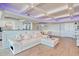 Bright living space featuring a modern white sofa, open layout, and coffered ceiling with stylish lighting at 9650 Shore Dr. # 503, Myrtle Beach, SC 29572