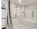 Modern shower with white tiled walls, built-in bench, and accessibility features for comfortable use at 9650 Shore Dr. # 503, Myrtle Beach, SC 29572