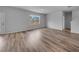 Open-concept living room featuring luxury vinyl plank flooring and abundant natural light at 1018 Laconic Dr., Myrtle Beach, SC 29588