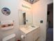 Bathroom featuring a white vanity with sink, toilet, and a wall mirror at 1058 Sea Mountain Hwy. # 202, North Myrtle Beach, SC 29582