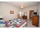 Bedroom with a bed with a quilt and nautical theme, bright light and wood dresser at 1058 Sea Mountain Hwy. # 202, North Myrtle Beach, SC 29582