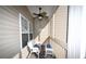 Screened porch with a white wicker chair and table at 1058 Sea Mountain Hwy. # 202, North Myrtle Beach, SC 29582