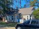 Spacious backyard featuring a well-maintained lawn and a cozy covered back porch at 1061 Valley Dr., Calabash, NC 28467