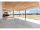 Expansive covered back porch with concrete flooring, ideal for outdoor entertaining and relaxation at 11455 W Highway 19, Loris, SC 29569