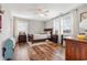 Bright bedroom with hardwood floors, an area rug, and a ceiling fan at 11455 W Highway 19, Loris, SC 29569