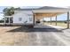 Side view of a home showcasing a carport and a covered back porch with views of the surrounding landscape at 11455 W Highway 19, Loris, SC 29569