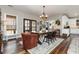 Bright dining room featuring hardwood floors, area rug, modern light fixture, and view into the kitchen at 11455 W Highway 19, Loris, SC 29569