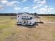 A lovely two story home with a full front porch, swing, and carport at 11455 W Highway 19, Loris, SC 29569