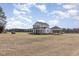 A full exterior shot of the two-story home featuring a full porch and convenient carport at 11455 W Highway 19, Loris, SC 29569