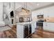 A spacious kitchen featuring an island with a wine cooler and a brick accent wall with fireplace at 11455 W Highway 19, Loris, SC 29569