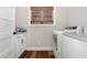 Efficient laundry room with white cabinetry, modern washer, dryer, and window for natural light at 11455 W Highway 19, Loris, SC 29569