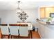 Elegant dining area featuring a modern chandelier, a wall mirror, and access to the kitchen at 1155 Harvester Circle # 1155, Myrtle Beach, SC 29579